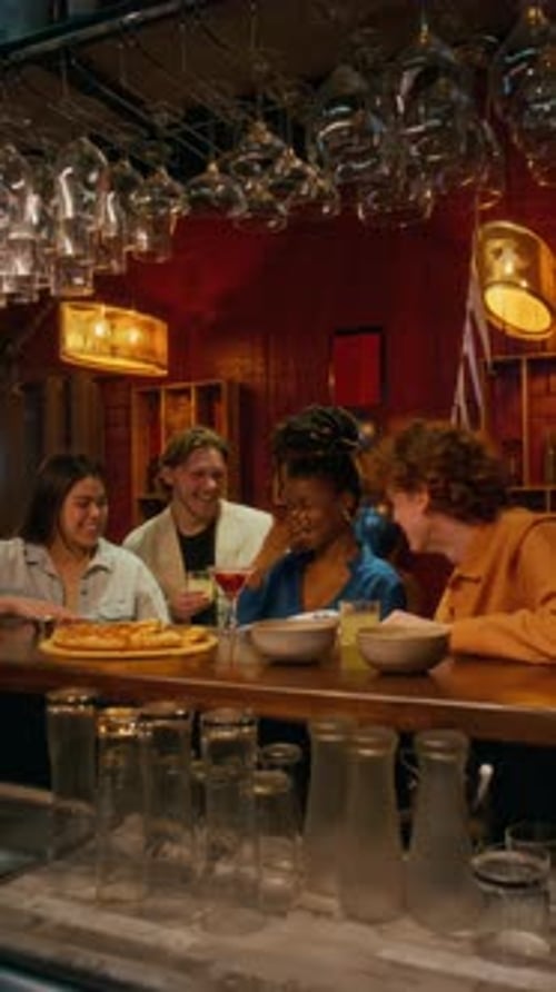 Group of Friends Toasting and Clinking Glasses, Celebrating Birthday in Bar