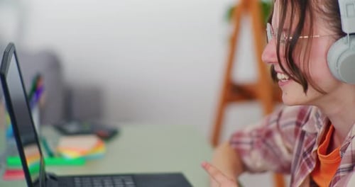 Woman Smiles and Talks on Laptop Video Call