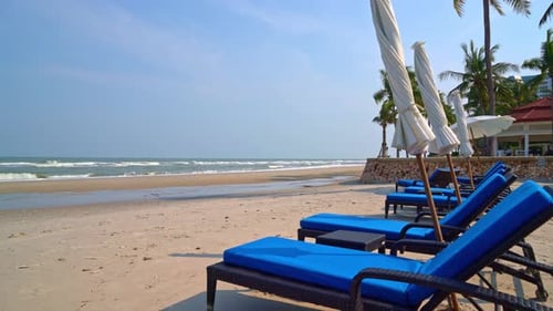 empty beach chair on beach with sea and blue sky background