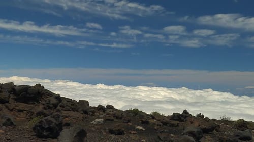 Vue grand angle du sommet rocheux au-dessus des nuages dans le parc national de Haleakala, Hawaï