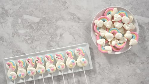 Flat Lay Step By Step Transfering Freshly Baked Unicorn Meringue Pops Cookies From the Baking Sheet