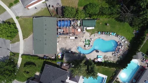 Aerial view of swimming pools in the backyards of houses 4K
