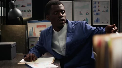 Colleagues Collaborating and Reviewing Documents in Office