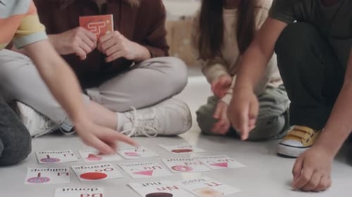 Teacher and Children Playing Educational Flashcard Game