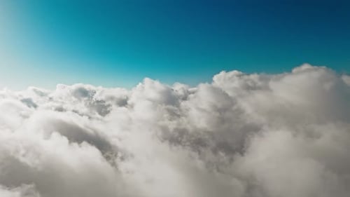 Aerial View of Fluffy White Clouds and Blue Sky
