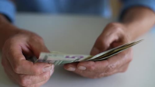 Close Up Counting United States Currency Money by Hand