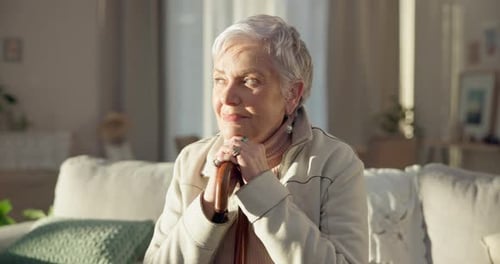 Senior Woman Relaxing With Cane on Sofa
