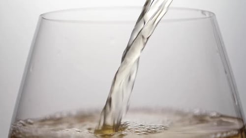 Beer Pouring Into Glass Close-Up with Bubbles