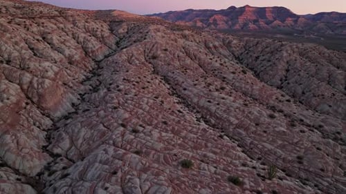 Experience a Stunning Aerial View of a Beautiful Colorful Desert Landscape at Sunset