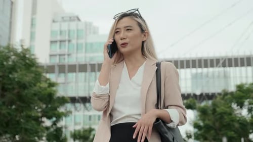 Professional Woman Talking on Phone in Urban Setting
