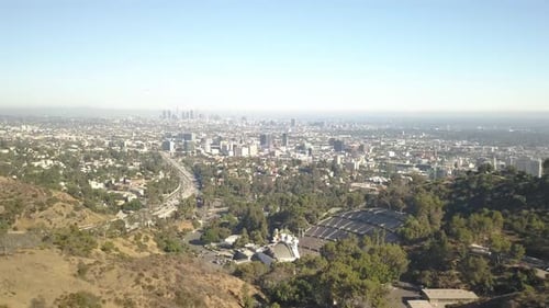 Slow push in aerial shot of city of los angeles from a hill high up location