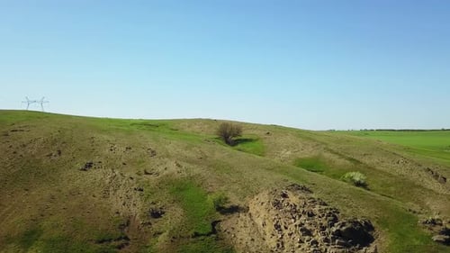 Aerial Footage of Camera Flying Over the Picturesque Valley Green Fields and Hills Rocky Cliffs and