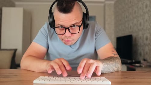 Man with Mohawk Typing on Keyboard, Makes Faces