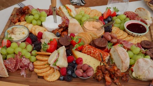 Close Up of charcuterie board of healthy food slow and smooth track vibrant outdoors during the day