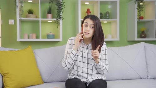 Woman on Phone Call Sitting on Couch at Home