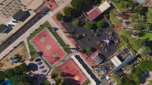 Aerial Video Aerial View of a Basketball Game With Players Running and Shooting on an Outdoor Court