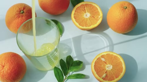 Fresh Orange Juice Being Poured into Glass