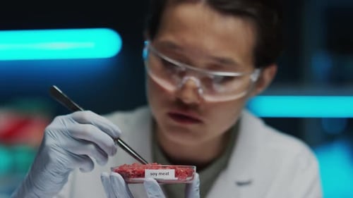 Scientist Examining Soy Meat Sample in Petri Dish