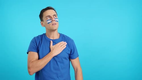 Man Listening to the El Salvador National Anthem with Solemnity