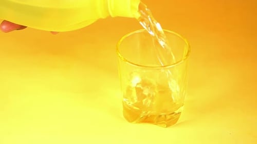 Pouring Water into Glass with Ice