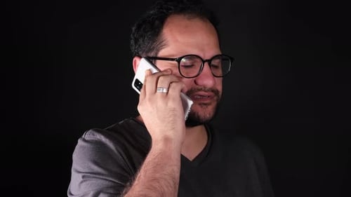 Man Talks on Phone in Studio Setting