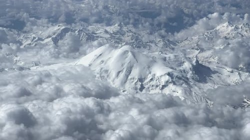 Aerial View of Steep Rocky Snowcapped Mountain Range on Beautiful Sunny Day