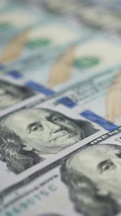 Vertical Screen Dolly Shot of US Dollar Bills Lying in Row