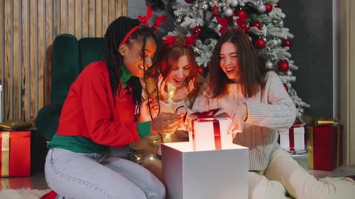 Friends Celebrating Christmas Opening Magical Gift Box