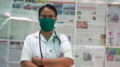 Healthcare Professional with Stethoscope Poses in Front of News
