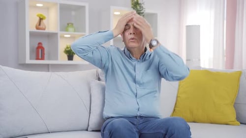 Senior Man Massaging Temples Suffering Headache