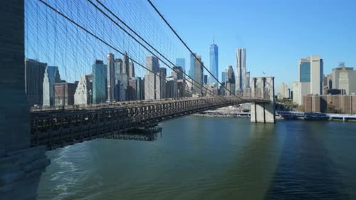 Forwards Fly Along Brooklyn Bridge with Iconic Lower Manhattan Skyscrapers in Background