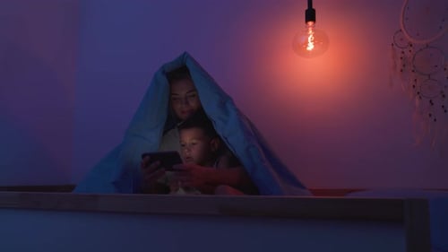 Mother and Child Bonding with Phone in Dark Room