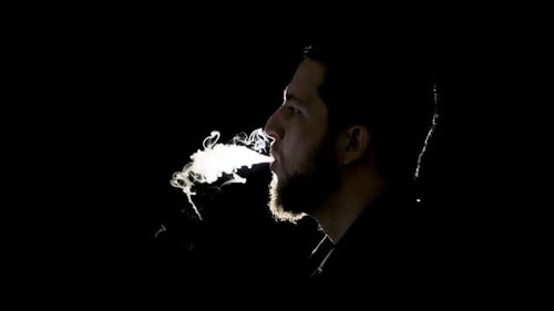 Bearded Man Vaping and Exhaling Smoke Close Up