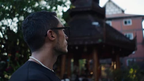Closeup of the Face of a Latino Boy Wearing Glasses Admiring the Beauty of Buddhist Temples in