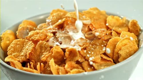 Milk Poured into Bowl of Crunchy Cornflakes