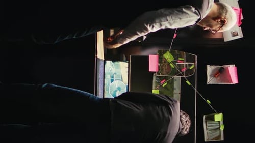 Intense Investigation: Two Men Examining Crime Evidence