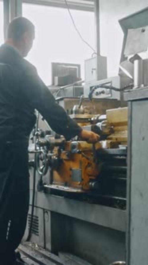 Metalworking machine producing metal parts in industrial factory setting