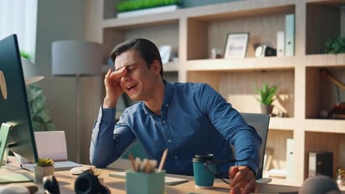 Frustrated Young Adult Working at Computer