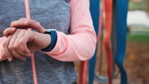 Woman Using Smart Watch in the City