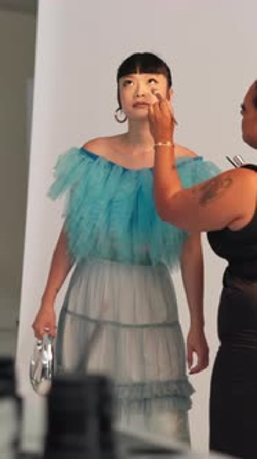 BTS, makeup and photoshoot with model in studio for advertising campaign or fashion magazine