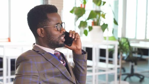 Man Talking on Smart Phone in Office