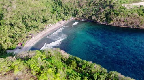 Aerial View Of Turquoise Gamat Bay With Waves And Tropical Palm Paradise On Sandy Beach In Nusa Peni