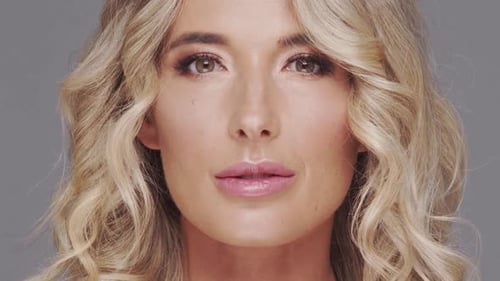 Studio Portrait of Young and Beautiful Blond Woman Over Grey Background Skin Care and Wellness