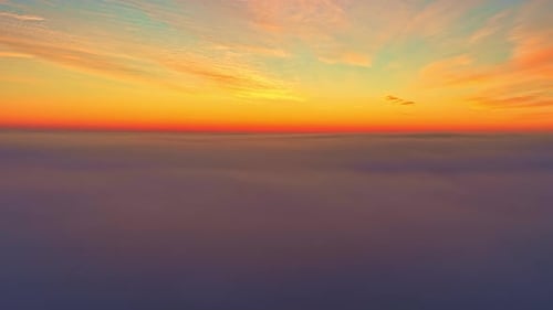 Aerial View of Colorful Sunset Sky Above Clouds in Serene Atmosphere