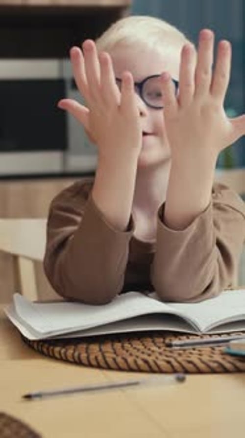 Young Boy Doing Math Homework With Help