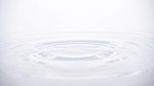 Water Drop Creates Expanding Circular Ripples
