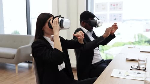 Business Colleagues Using Virtual Reality Headsets in Modern Office