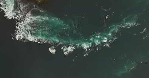 Aerial View of Boat Navigating Turbulent Waters