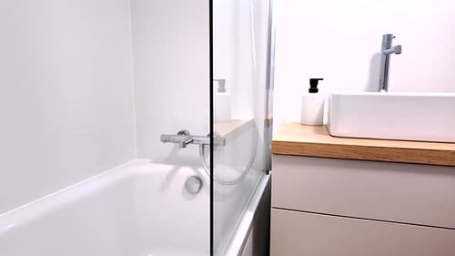 Small bathroom, with a bathtub and a place for a shower, modern, practical, subdued colors