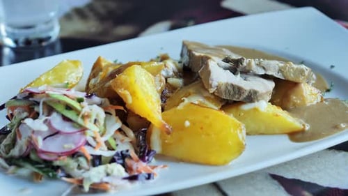 Delicious Plated Meal with Meat, Potatoes, and Salad